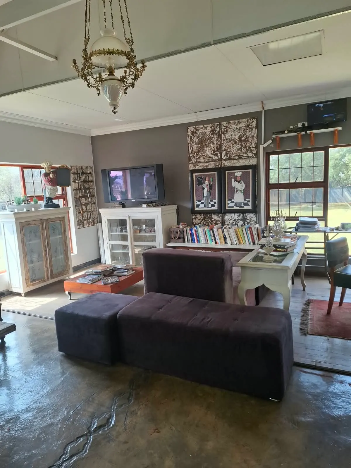 Student lounge with a cookbook library, chandelier and garden views