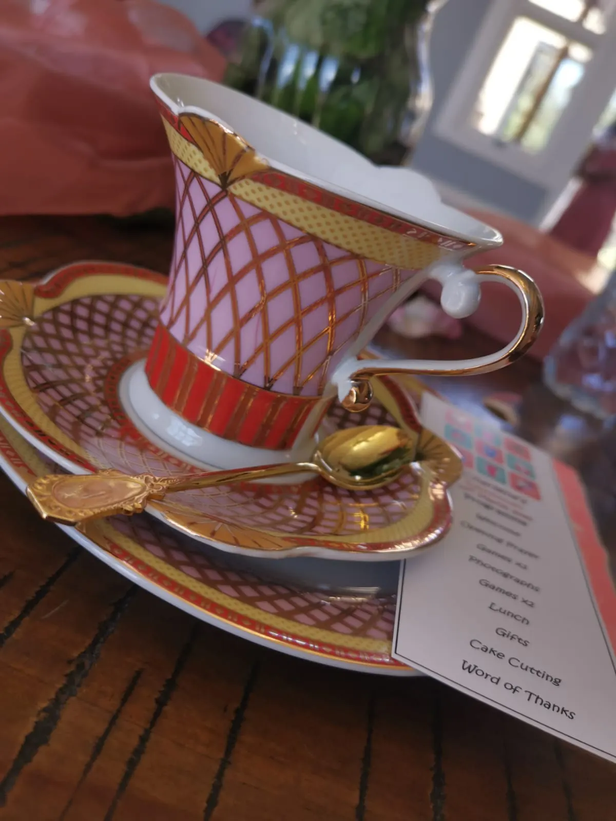 Pink and gold porcelain teacup with a gilded spoon