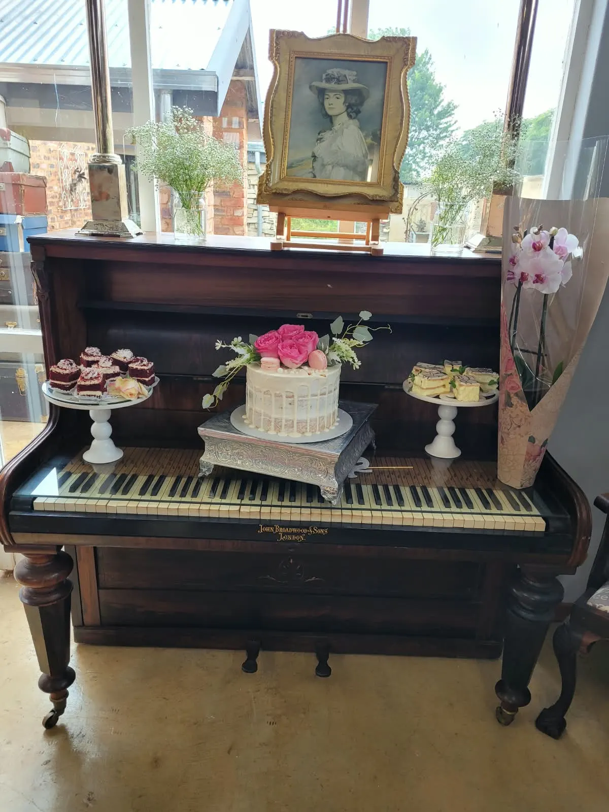 Antique piano set with red velvet cakes, a rose cake and mille-feuille